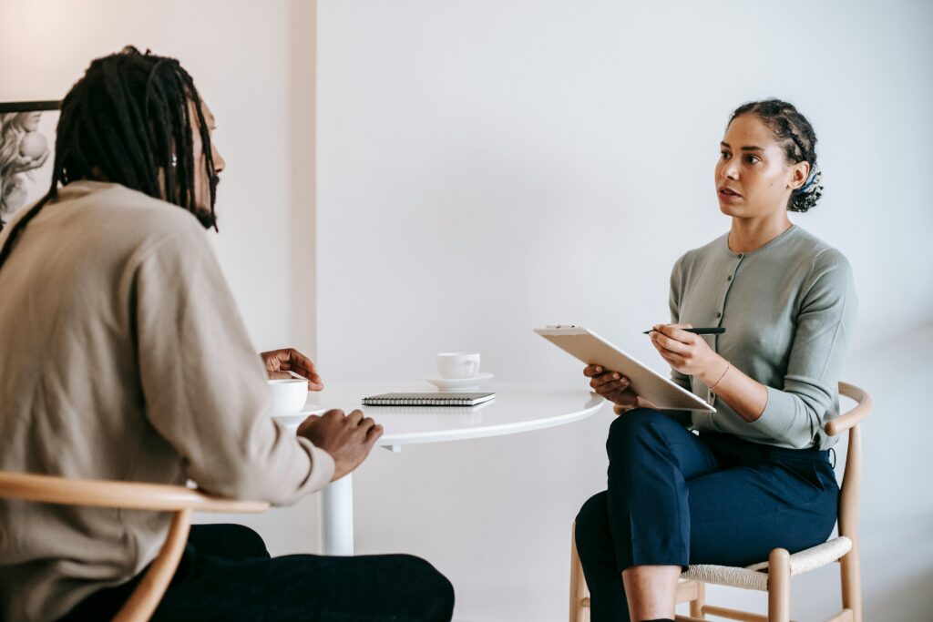 A professional job interview between a man and woman in a modern office setting.